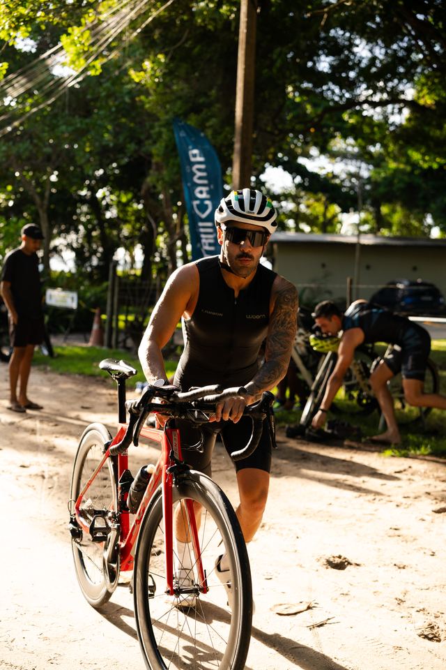 Atleta saindo da transição com a bike
